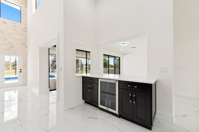 bar with a high ceiling and beverage cooler