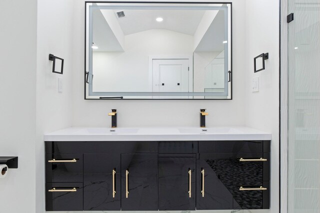 bathroom with lofted ceiling, an enclosed shower, and vanity