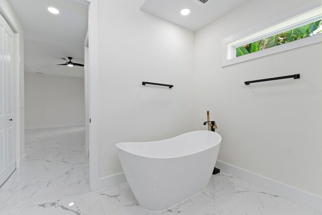 bathroom featuring ceiling fan and a bathtub