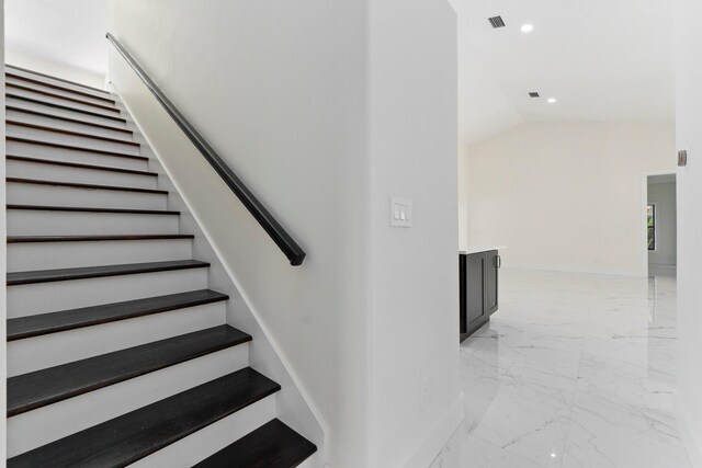 staircase with vaulted ceiling