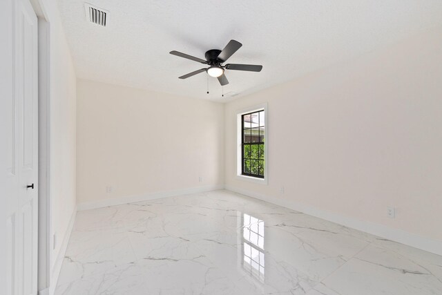 unfurnished room with a textured ceiling and ceiling fan