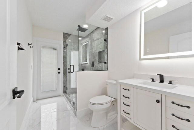 bathroom featuring a textured ceiling, vanity, toilet, and walk in shower