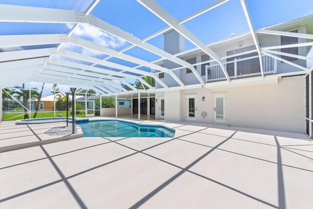 view of pool featuring a lanai and a patio