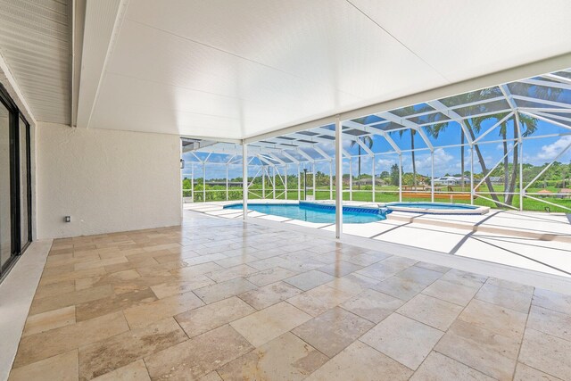 view of pool with glass enclosure and a patio area