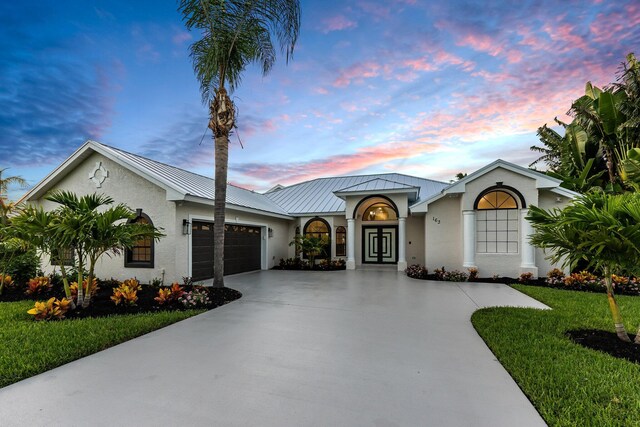 single story home featuring a yard and a garage