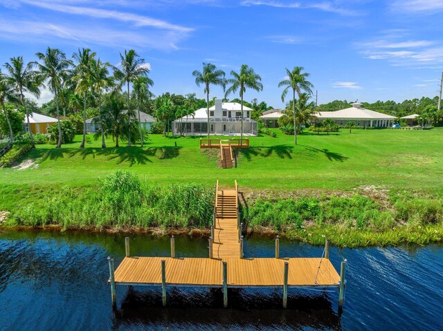 view of dock featuring a water view and a lawn