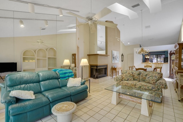 living room featuring rail lighting, ceiling fan, high vaulted ceiling, and a multi sided fireplace