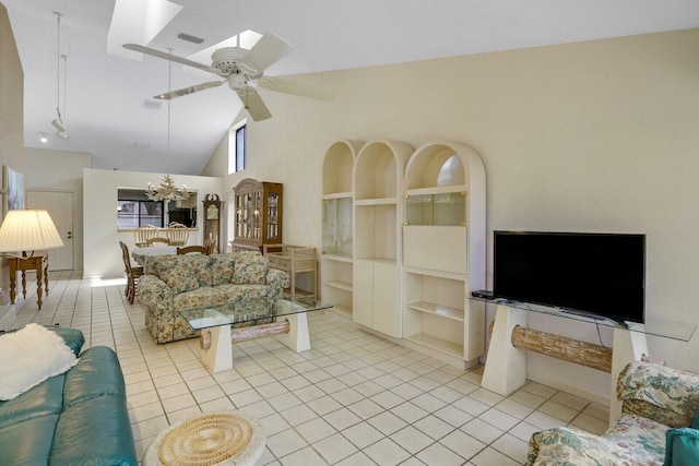 tiled living room featuring ceiling fan with notable chandelier, high vaulted ceiling, and built in shelves