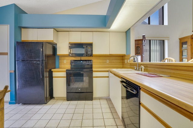 kitchen with black appliances, tasteful backsplash, light tile patterned floors, and sink