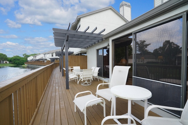 wooden terrace featuring a water view and a pergola