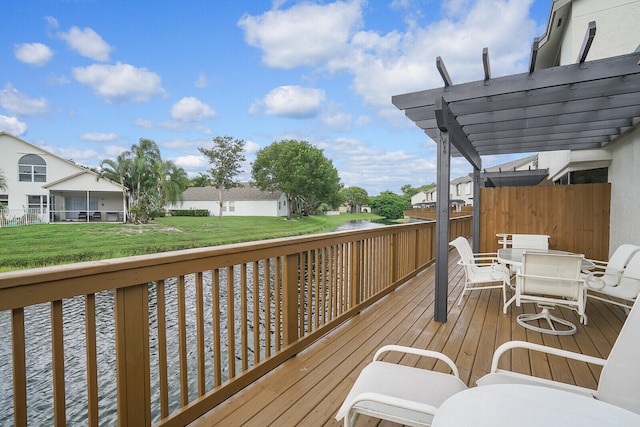 wooden deck featuring a lawn and a pergola