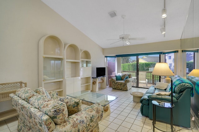 living room featuring vaulted ceiling, a healthy amount of sunlight, light tile patterned floors, and ceiling fan