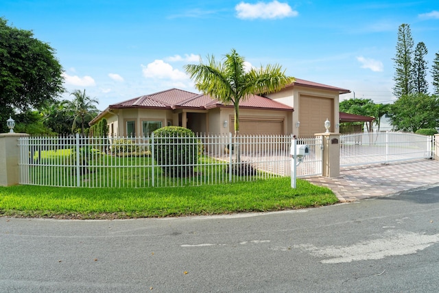 view of front of house featuring a garage and a front yard