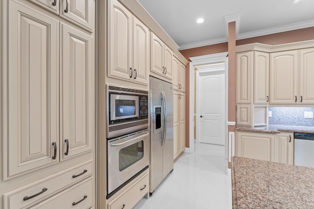 kitchen with decorative backsplash, ornamental molding, cream cabinets, and stainless steel appliances