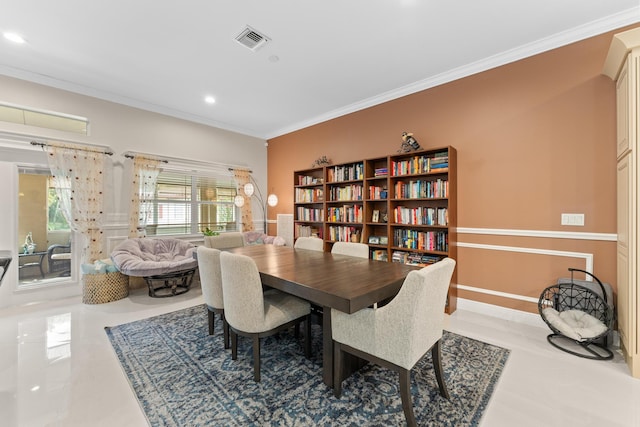 tiled dining area featuring crown molding