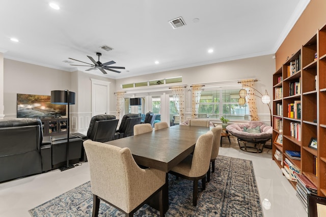 dining area with ornamental molding, ceiling fan, and french doors