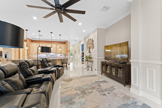 living room with ceiling fan and crown molding