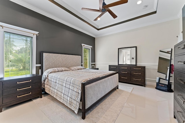 bedroom with ceiling fan, a raised ceiling, multiple windows, and crown molding