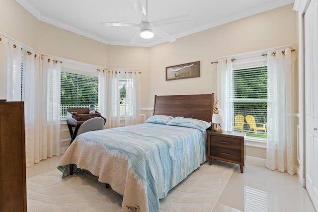 bedroom featuring crown molding, light tile patterned flooring, ceiling fan, and a closet