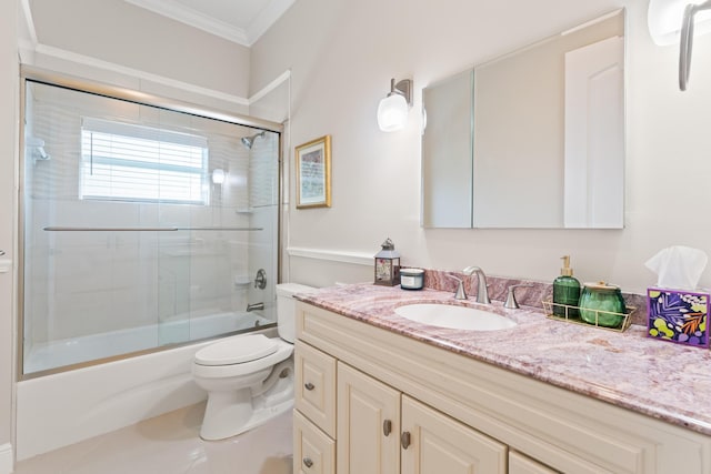 full bathroom featuring vanity, crown molding, enclosed tub / shower combo, and toilet