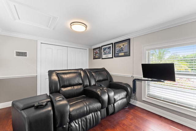 home theater with ornamental molding and dark hardwood / wood-style flooring