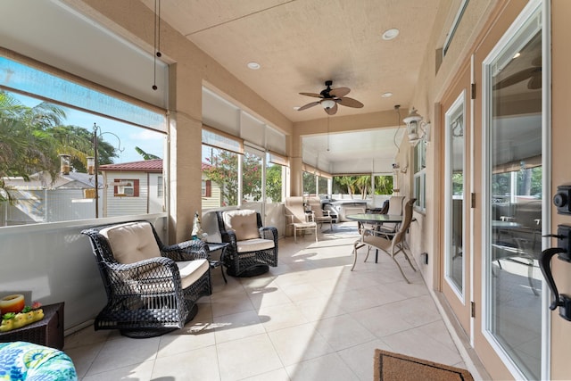 sunroom featuring ceiling fan