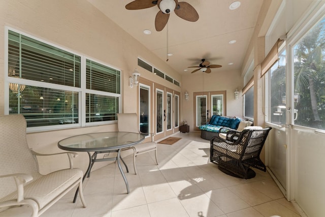 sunroom / solarium with ceiling fan and french doors