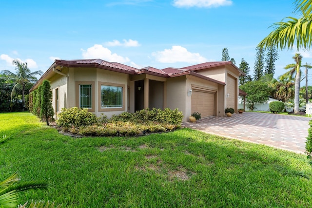 mediterranean / spanish house featuring a garage and a front yard