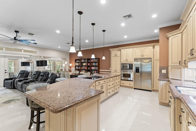 kitchen featuring a center island, hanging light fixtures, stone counters, stainless steel appliances, and ornamental molding