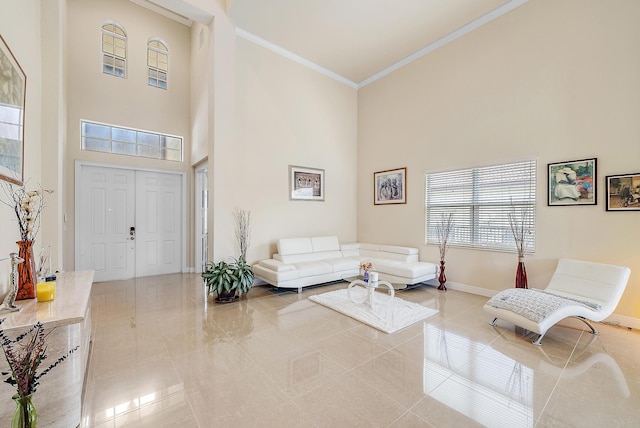 living room featuring a towering ceiling, light tile patterned floors, and crown molding