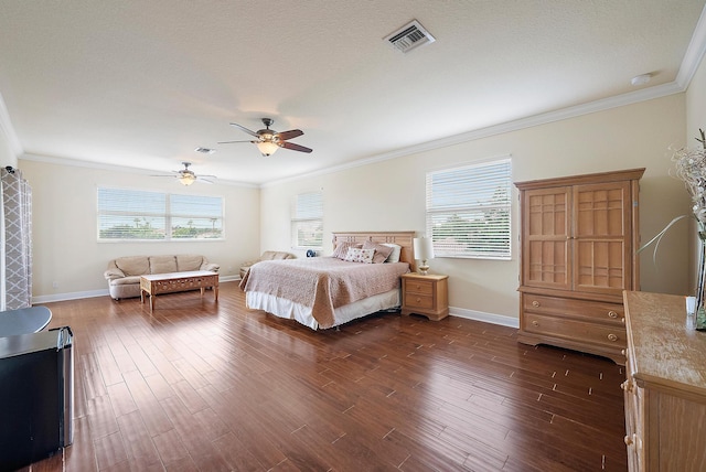 bedroom featuring ornamental molding, dark hardwood / wood-style flooring, a textured ceiling, and ceiling fan