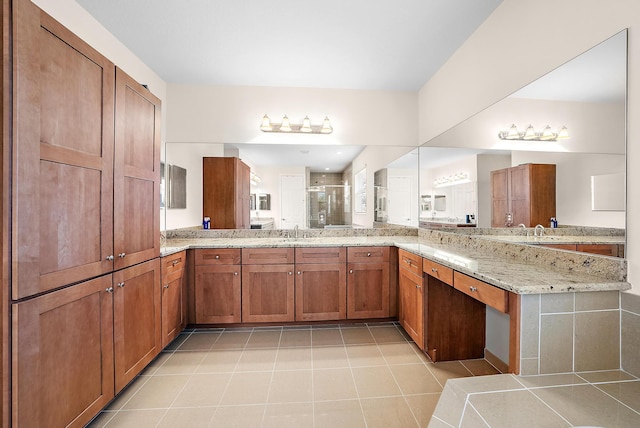 bathroom with vanity and a shower with door