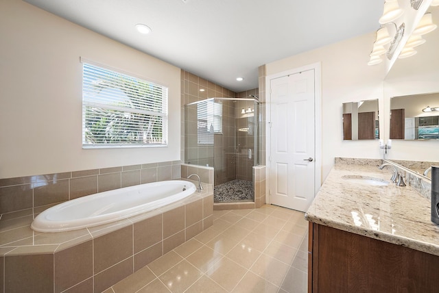 bathroom featuring independent shower and bath, vanity, and tile patterned floors