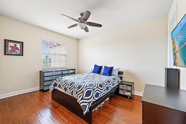 bedroom with dark wood-type flooring and ceiling fan