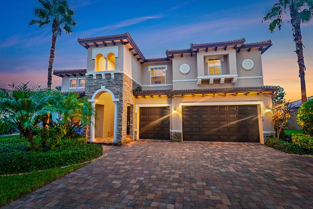 mediterranean / spanish-style home with a garage