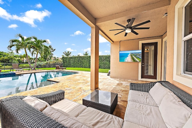 view of swimming pool featuring ceiling fan, a patio, and an outdoor living space