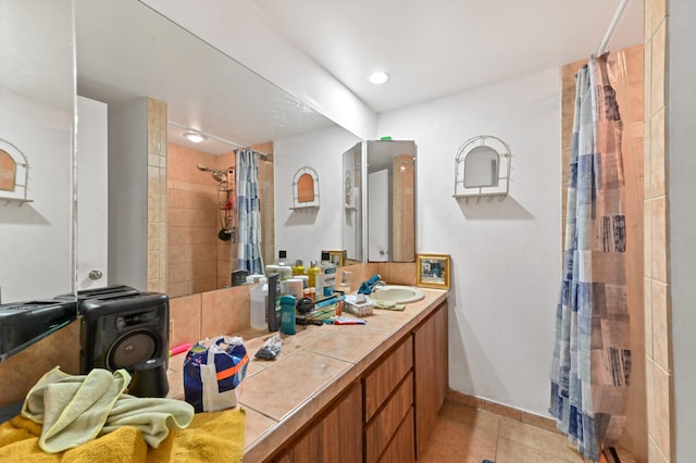 bathroom featuring tile patterned floors, curtained shower, and vanity