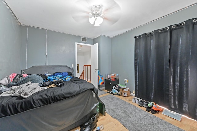 bedroom featuring hardwood / wood-style floors and ceiling fan