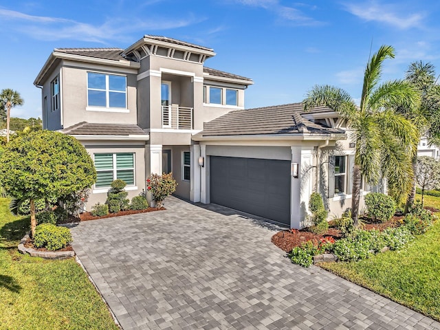 view of front of home with a balcony and a garage