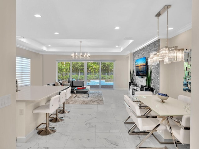 dining area featuring a tray ceiling, crown molding, and a notable chandelier