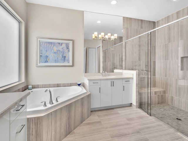 bathroom featuring vanity, separate shower and tub, and a chandelier