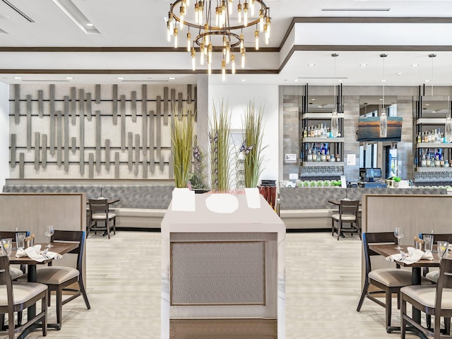 interior space featuring bar area and a notable chandelier