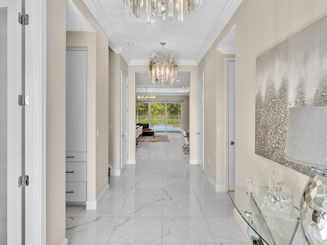 hall featuring crown molding and an inviting chandelier