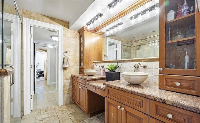 bathroom featuring tile walls, walk in shower, and vanity