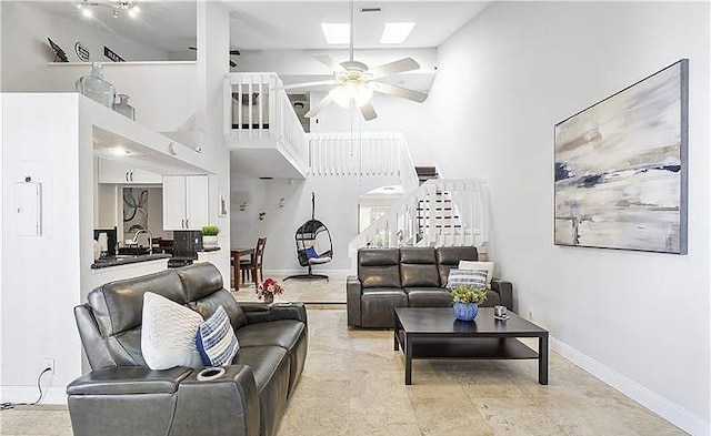 living room with high vaulted ceiling and ceiling fan