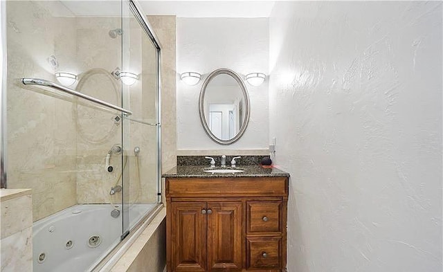 bathroom with tiled shower / bath and vanity