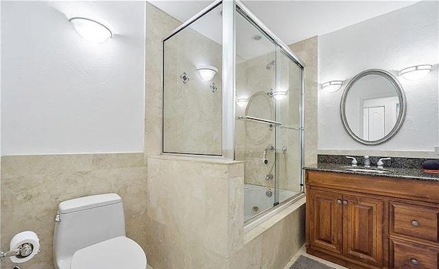 full bathroom featuring shower / bath combination with glass door, vanity, and toilet