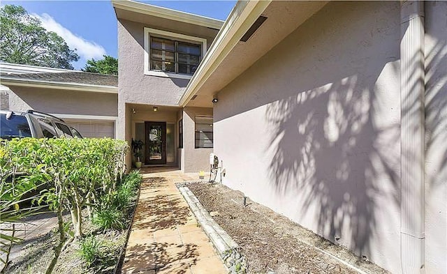 view of exterior entry with a garage