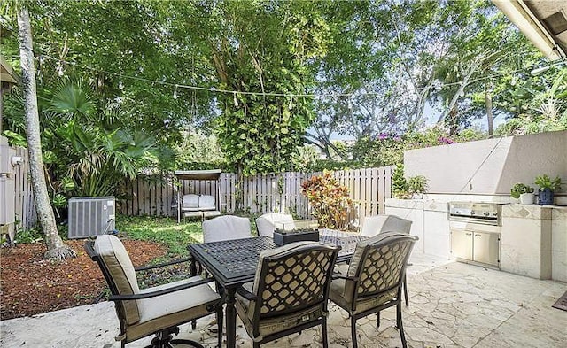 view of patio featuring exterior kitchen, central AC unit, and outdoor lounge area