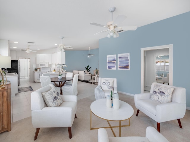 living room with vaulted ceiling, ceiling fan, and light colored carpet